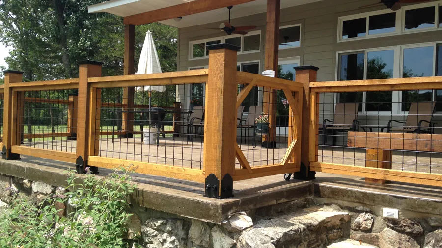 A rustic wood railing setup with decorative Wild Hog wire panels installed