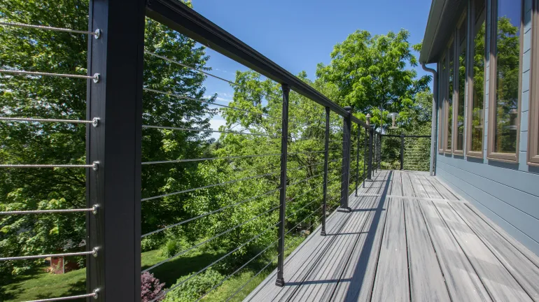 A beautiful cable deck railing system, sometimes called a wire deck railing, installed on a deck to open up the deck view