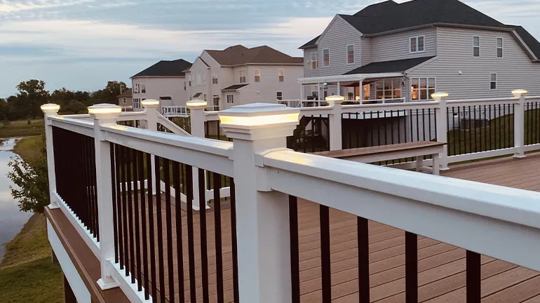 An example of classy DIY deck lighting using post cap deck lights on a stylish railing