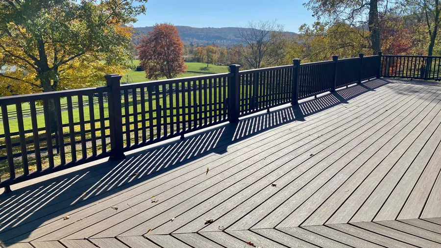 A wide open deck with a beautiful nature view, featuring Trex Enhance Toasted Sand deck boards