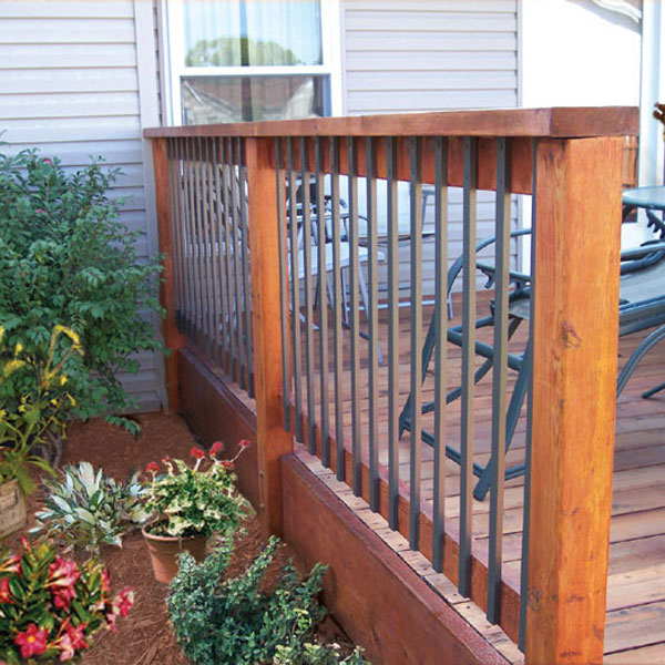 A wood deck railing with sleek steel balusters face-mounted for easy installation and easy maintenance