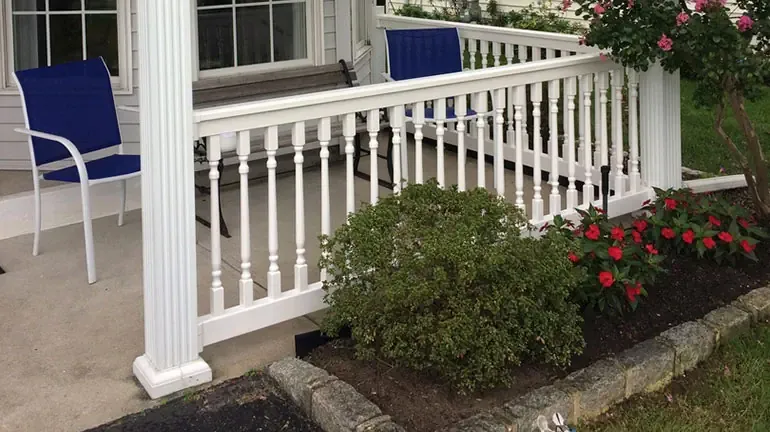 A traditional deck with vinyl railing and ornate turned balusters