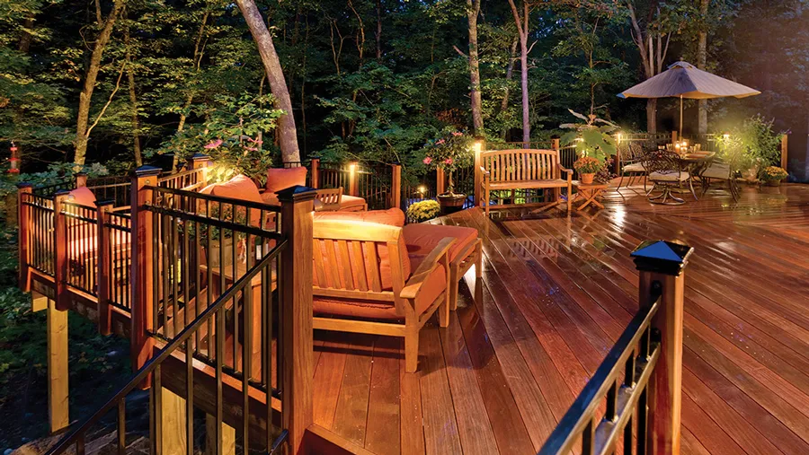 A gorgeous deck with sleek steel railing panels installed between classic wood posts