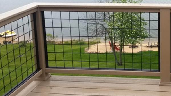 A classic Trex Transcend railing with distinctive mesh paneling from Wild Hog Railings inside
