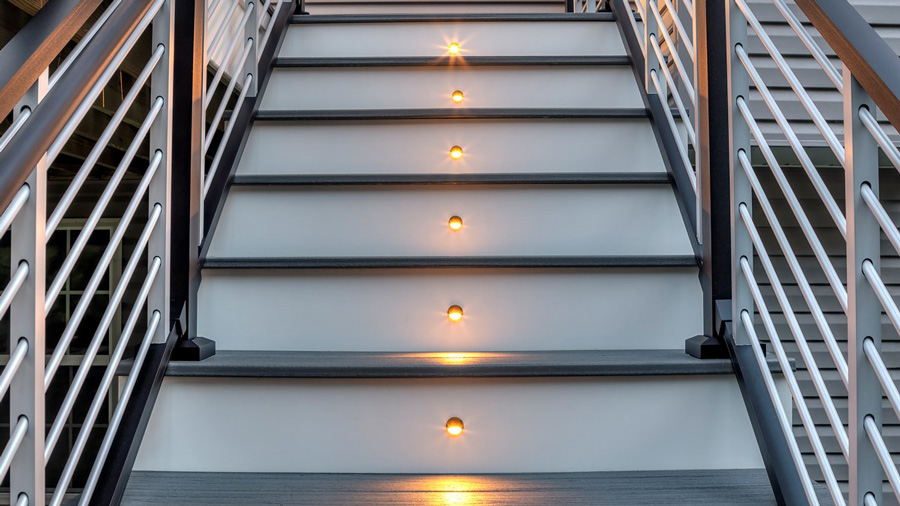 Brightly lit deck stairs with recessed LEDs casting light onto each step
