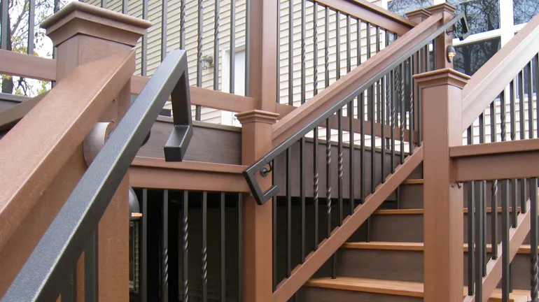 A set of extra-safe deck stairs with Fortress metal handrails installed along the railing