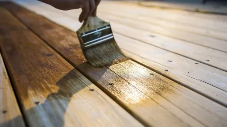 A wood deck being stained to protect from weather damage to the boards