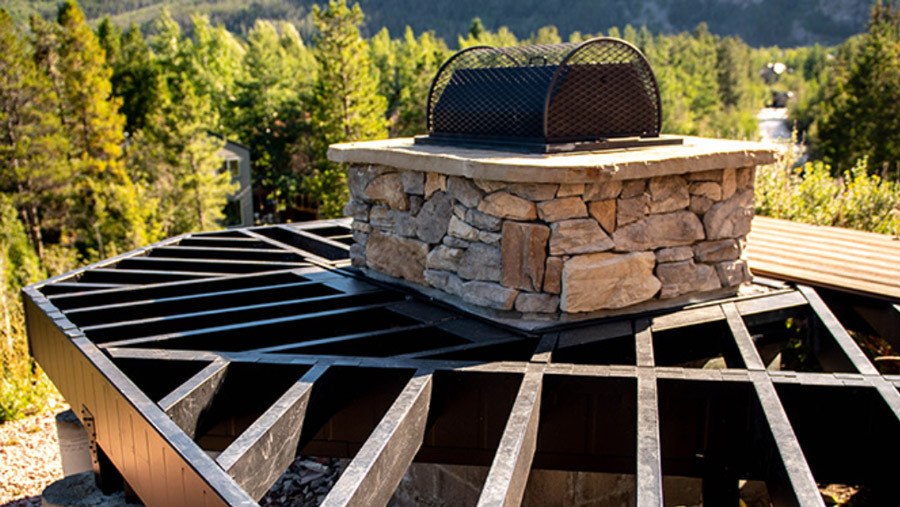 A steel deck frame build around a sizable fireplace
