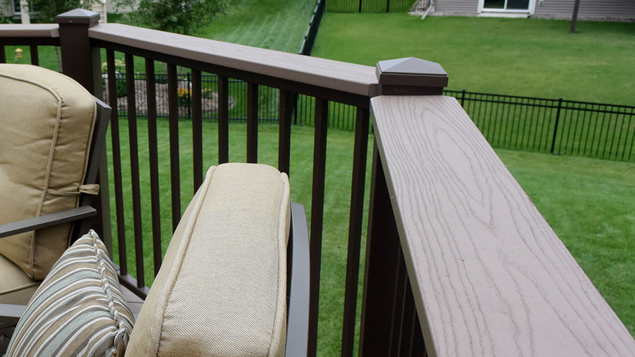A sleek metal railing with a deck board drink rail