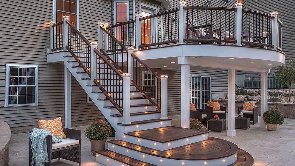 A gorgeous, top-to-bottom Trex deck lighting setup including post caps and recessed stair lights