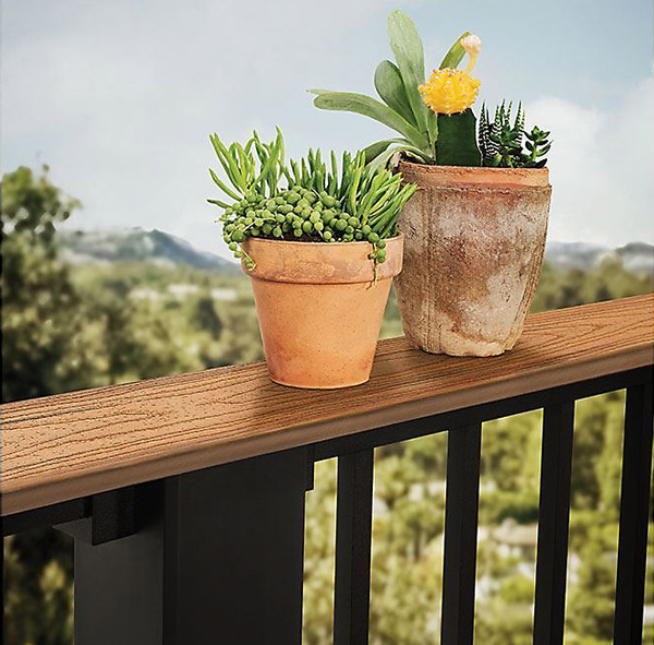 Trex Signature Railing with a deck board drink rail adorned with flower pots