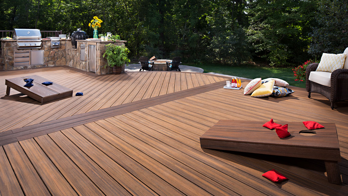 A well-designed deck made of Trex composite decking with yard games set up