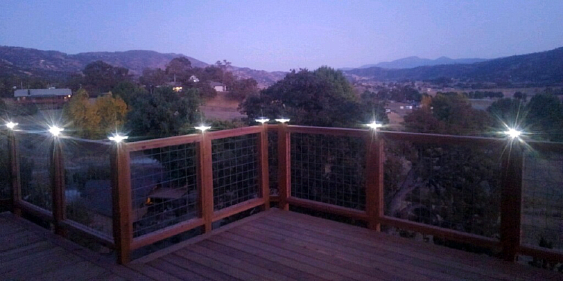 Powder-coated aluminum solar post cap lights and solar deck lighting from Classy Caps are in stock to help illuminate your fence or deck railing much like this Californian home