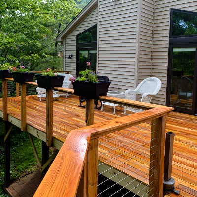 Adding a continuous drink rail atop your deck railing layout creates a wider looking outdoor space inviting guests to come and relax