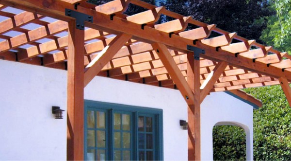 Keep your outdoor space cool and relaxing with an awesome patio cover connected to your home