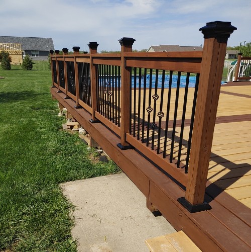 Metal deck balusters from Deckorators and Fortress bring new life to this poolside deck and patio area diy deck build
