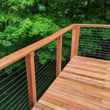 Our Deck of the Month winner installed Feeney CableRail cable railing between rich Cedar posts to create a stunning and strong deck railing you can nearly see-through completely