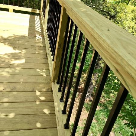Knowing how to clean metal balusters, such as these Deckorators aluminum balusters installed on wood deck rails, can keep your deck looking fresh