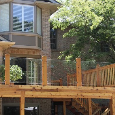 Mount tempered glass panels between your wood deck posts for a long-lasting and beautiful deck aesthetic