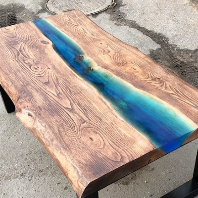 One of the most popular deck design options of 2020 is creating your own one-of-a-kind epoxy resin drink rail board to add art and creativity to your outdoor living space - photo via Resin-Expert.com